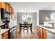 Warm dining area with wood floors, a cozy dining table, and view of the fenced-in backyard at 6102 Boulder Dr, Anderson, IN 46013