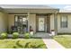 Inviting covered front porch with seating area, decorative plants, and 'Welcome' sign at 6102 Boulder Dr, Anderson, IN 46013