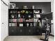 Well-organized home office featuring custom shelving, a stationary bike, and a minimalist decor at 6102 Boulder Dr, Anderson, IN 46013
