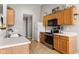 Functional kitchen featuring wood cabinets, white countertops, and stainless steel appliances at 6102 Boulder Dr, Anderson, IN 46013