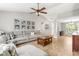 Spacious living room with vaulted ceiling, wood floors, and a large sectional sofa at 6102 Boulder Dr, Anderson, IN 46013
