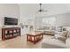 Open living room featuring wood floors, a large sectional sofa, and view of the dining area at 6102 Boulder Dr, Anderson, IN 46013