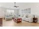 Bright living room with wood flooring, a large sectional sofa, and natural light from the windows at 6102 Boulder Dr, Anderson, IN 46013