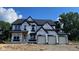 New two-story home featuring a three-car garage, black roof, and bright white windows at 6279 Rippling Rock Dr, Plainfield, IN 46168