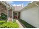 Inviting front entrance with red door, brick accents, and manicured landscaping at 6928 Shoals Way, Indianapolis, IN 46237