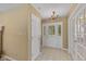Entryway with a glass door, tile flooring, and classic chandelier lighting at 6928 Shoals Way, Indianapolis, IN 46237
