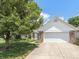 Traditional home with a two-car garage, brick accents, and mature landscaping at 6928 Shoals Way, Indianapolis, IN 46237