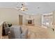 Open-concept living room features a brick fireplace, neutral paint, and a ceiling fan at 6928 Shoals Way, Indianapolis, IN 46237