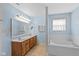 Light and airy main bathroom with a double vanity and soaking tub at 6928 Shoals Way, Indianapolis, IN 46237