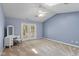 Spacious main bedroom with vaulted ceilings, fan, skylight, and outdoor access at 6928 Shoals Way, Indianapolis, IN 46237
