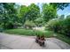 Private backyard oasis with lush greenery, fire pit, and patio perfect for outdoor entertaining at 7224 N Tuxedo St, Indianapolis, IN 46240