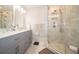 Modern bathroom with tiled walk-in shower, gray vanity, and sleek fixtures offers a spa-like experience at 7224 N Tuxedo St, Indianapolis, IN 46240