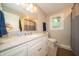 Bright bathroom featuring white vanity, ample counter space, and a window for natural light at 7224 N Tuxedo St, Indianapolis, IN 46240