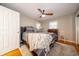 Cozy bedroom features soft carpet, a ceiling fan, and a natural light for a relaxing atmosphere at 7224 N Tuxedo St, Indianapolis, IN 46240