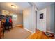 Bedroom area with writing desk, wood floors, and neutral walls leading into a doorway at 7224 N Tuxedo St, Indianapolis, IN 46240