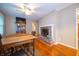 The dining room features wood floors, a brick fireplace, and stylish decor for entertaining guests at 7224 N Tuxedo St, Indianapolis, IN 46240