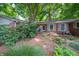 A classic brick home with a brick path and lush garden offers timeless appeal at 7224 N Tuxedo St, Indianapolis, IN 46240