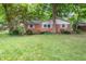 A well-maintained lawn and garden accentuate this charming brick home at 7224 N Tuxedo St, Indianapolis, IN 46240