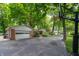 This home features a detached garage and basketball hoop, all surrounded by mature trees at 7224 N Tuxedo St, Indianapolis, IN 46240