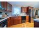 This home's updated kitchen features wood cabinets, stainless steel appliances, and modern finishes at 7224 N Tuxedo St, Indianapolis, IN 46240