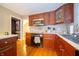 Well-lit kitchen boasts stainless appliances, wood cabinets, and seamless access to the adjacent rooms at 7224 N Tuxedo St, Indianapolis, IN 46240