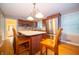 Bright kitchen features stainless steel appliances, custom cabinets, and a central island with seating at 7224 N Tuxedo St, Indianapolis, IN 46240
