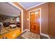 Inviting entryway with hardwood floors transitioning into a living room with a comfortable leather sofa at 7224 N Tuxedo St, Indianapolis, IN 46240