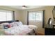 Bright bedroom with floral bedding, natural light, and comfortable furnishings at 7326 Lowe Dr, Lawrence, IN 46226