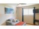 This is a bedroom area featuring a cushioned chair, large window, and wall art at 7326 Lowe Dr, Lawrence, IN 46226