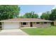 Charming single-story home featuring a stone facade, attached garage, and well-manicured lawn at 7326 Lowe Dr, Lawrence, IN 46226
