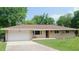 Charming one story home features a long driveway, an attached garage, and curb appeal at 7326 Lowe Dr, Lawrence, IN 46226