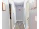 Hallway with hardwood floors and contemporary gray paint at 7326 Lowe Dr, Lawrence, IN 46226