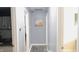 Inviting hallway featuring grey walls, hard flooring, and decor at 7326 Lowe Dr, Lawrence, IN 46226