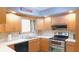 This is a kitchen with stainless steel appliances, bright countertop, and wooden cabinetry at 7326 Lowe Dr, Lawrence, IN 46226