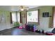 This bright living room has large windows and equipment for exercise at 7326 Lowe Dr, Lawrence, IN 46226