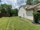 View of the spacious backyard with a lush lawn and a partial fence at 7450 Cobblestone W Dr, Indianapolis, IN 46236