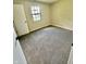 Cozy bedroom features neutral walls, window with blinds, and plush carpeting, offering a comfortable retreat at 7450 Cobblestone W Dr, Indianapolis, IN 46236