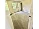 Bedroom with tan carpet, a window, and a white door at 7450 Cobblestone W Dr, Indianapolis, IN 46236