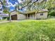 Charming stone home features a well-maintained lawn, covered porch, and attached two-car garage at 7450 Cobblestone W Dr, Indianapolis, IN 46236