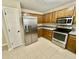 Bright kitchen with stainless steel appliances, wooden cabinets, and neutral countertops at 7450 Cobblestone W Dr, Indianapolis, IN 46236