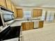 Kitchen featuring stainless appliances, wooden cabinets, granite countertops and tile flooring at 7450 Cobblestone W Dr, Indianapolis, IN 46236