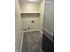 Functional laundry room with shelving and utility connections, featuring carpet flooring at 7450 Cobblestone W Dr, Indianapolis, IN 46236