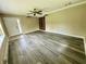 Open living area featuring updated flooring, neutral walls, ceiling fan, and a bright front door at 7450 Cobblestone W Dr, Indianapolis, IN 46236