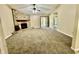 Living room with a stone fireplace, ceiling fan, carpet and entry doorway at 7450 Cobblestone W Dr, Indianapolis, IN 46236