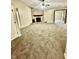 Spacious living room featuring carpet flooring and a stone fireplace at 7450 Cobblestone W Dr, Indianapolis, IN 46236