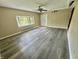 Bright, spacious room featuring light gray vinyl floors, ceiling fan, and a bay window at 7450 Cobblestone W Dr, Indianapolis, IN 46236