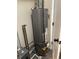 Water heater inside utility closet with all necessary piping, and a sealed concrete floor at 7450 Cobblestone W Dr, Indianapolis, IN 46236