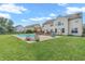 Backyard features a sparkling pool, patio area, green lawn, and fenced perimeter at 7830 Cross Creek, Avon, IN 46123