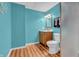 Bathroom featuring a bright turquoise color scheme, with vanity and toilet at 7830 Cross Creek, Avon, IN 46123