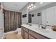 Bathroom with double sink vanity, mirror, and shower with curtain at 7830 Cross Creek, Avon, IN 46123